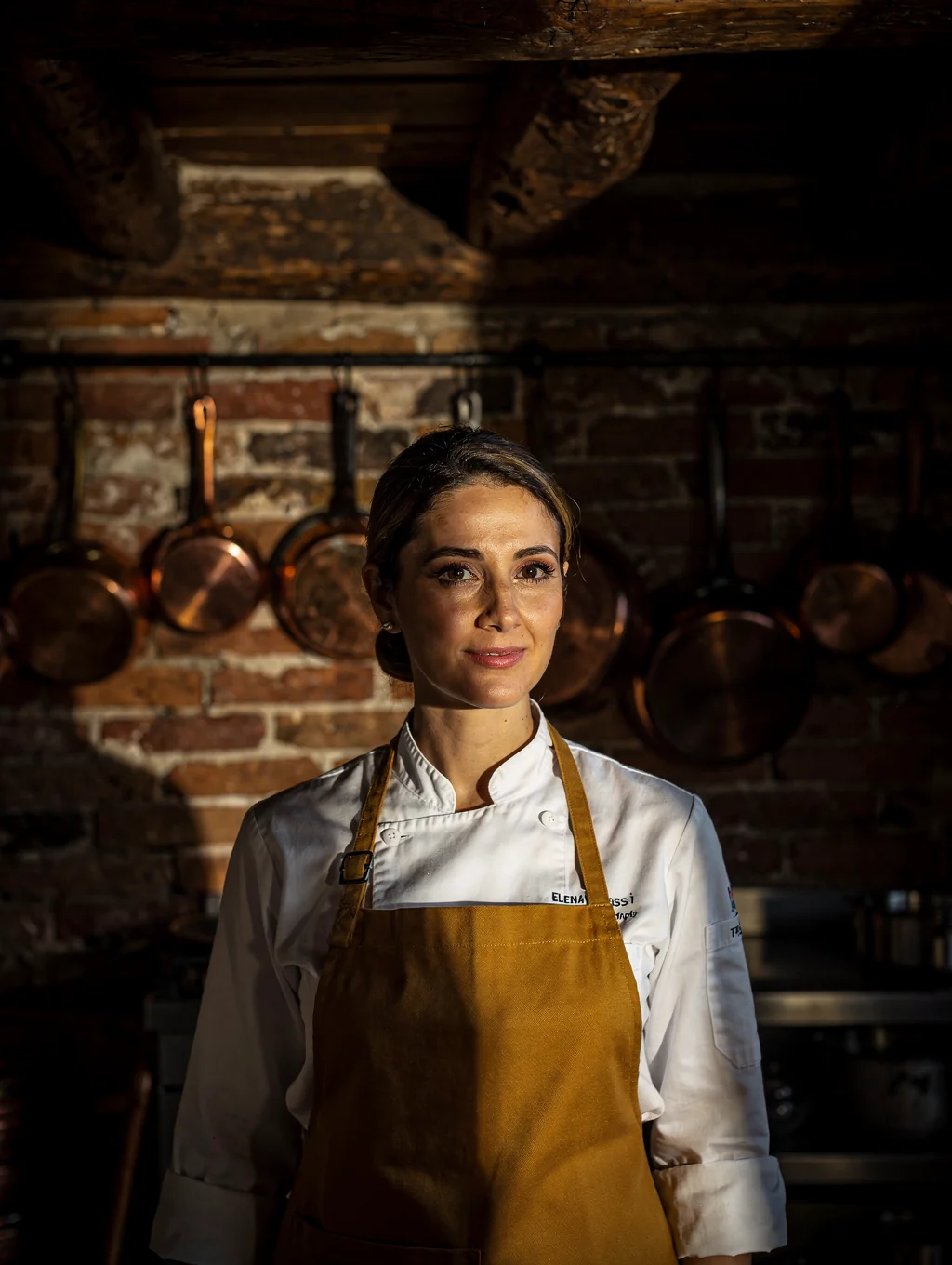 Chef Elena Moretti working at the wood-fired oven